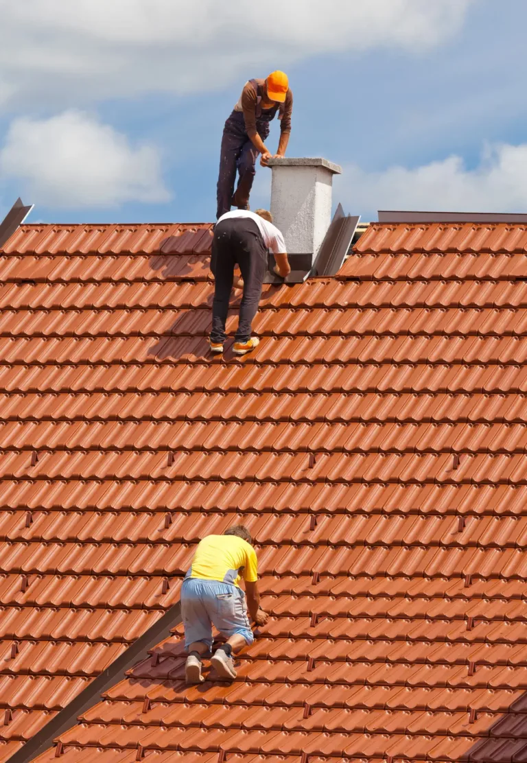 Three ASI Construction workers on roof installing a new roof